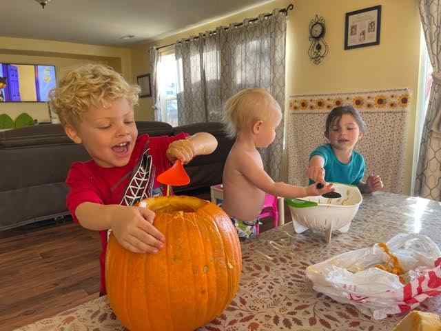 children carving pumpkins